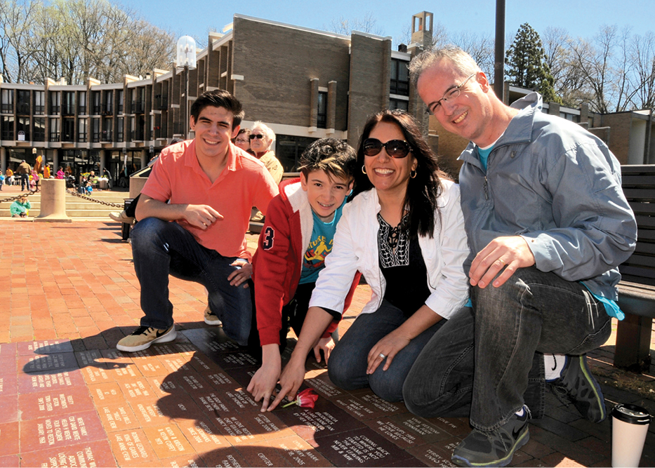 Letteri family pointing out at their brick at Lake Anne. Aaron, Joseph, Raba and Paul.