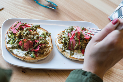Mini pita with protein, sumac radishes, and spicy leek dressing at Cava Grill